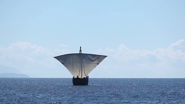 Sailboat floats in the sea or ocean, an old style ship on the water