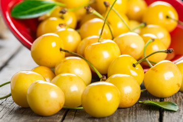 Yellow cherry on a wooden background
