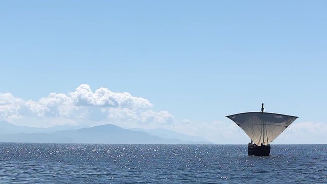 Sailboat floats in the sea or ocean, an old style ship on the water
