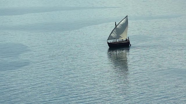 Sailboat floats in the sea or ocean, an old style ship on the water