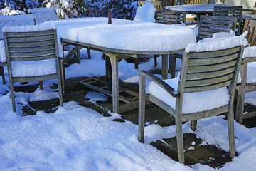 Snow on outdoor garden furniture after a blizzard snow storm