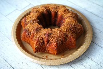 An apple cider ring cake with cinnamon sugar baked in a Bundt pan