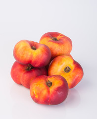 flat peaches (donut peaches) on a background