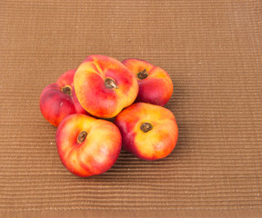 flat peaches (donut peaches) on a background