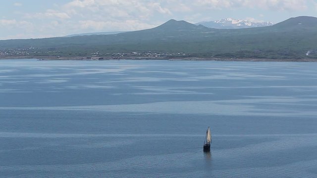 Sailboat floats in the sea or ocean, an old style ship on the water