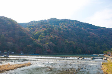 The stream flows through the weir in river at Arashiyama in Kyoto