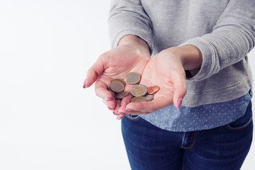Woman hands holding euro coins and giving them to camera. Isolated on white background. charity and almsgiving concept