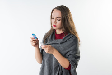 Choice of medicine between different pills and capsules. Woman holds two types of drugs Isolated on a white background with copyspace