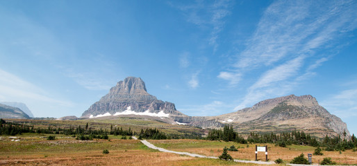 CLEMENTS MOUNTAIN TOWERING ABOVE THE HIDDEN LAKE HIKING TRAIL ON LOGAN PASS UNDER CIRRUS CLOUDS DURING THE 2017 FALL FIRES IN GLACIER NATIONAL PARK IN MONTANA UNITED STATES