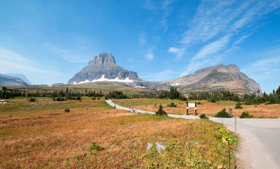 Fototapeta na wymiar CLEMENTS MOUNTAIN TOWERING ABOVE THE HIDDEN LAKE HIKING TRAIL ON LOGAN PASS UNDER CIRRUS CLOUDS DURING THE 2017 FALL FIRES IN GLACIER NATIONAL PARK IN MONTANA UNITED STATES