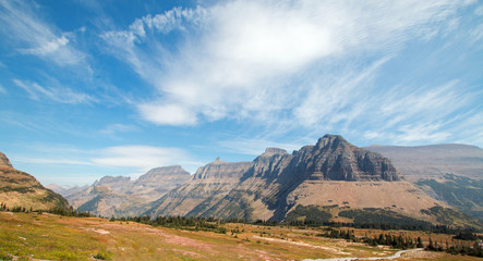HIDDEN LAKE HIKING TRAIL ON LOGAN PASS UNDER CIRRUS AND LENTICULAR CLOUDS DURING THE 2017 FALL FIRES IN GLACIER NATIONAL PARK IN MONTANA UNITED STATES