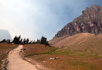 HIDDEN LAKE HIKING TRAIL ON LOGAN PASS UNDER CIRRUS AND LENTICULAR CLOUDS DURING THE 2017 FALL FIRES IN GLACIER NATIONAL PARK IN MONTANA UNITED STATES