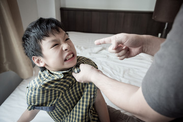 Young aggressive boy face expression when his father punish him by hitting © gamelover