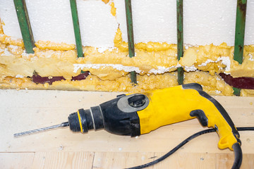 Electric drill on a wooden floor. Repairs in the room