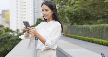 Asian Woman use of mobile phone in city