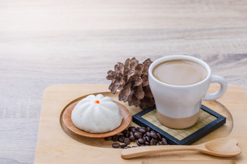 Coffee milk in the white cup and steam buns for breakfast.