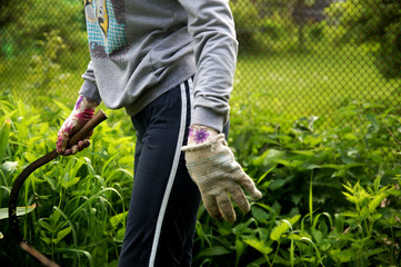 A young girl is engaged in gardening