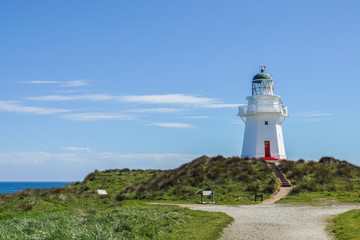 Fototapeta na wymiar vintage old lighthouse at seaside in New Zealand