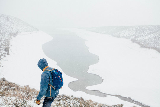Hiker hiking on snow mountain in winter
