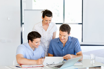 Fototapeta premium Group of happy young business people in a meeting
