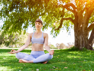 Young woman practicing yoga in the park