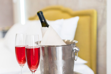 Honeymoon concept. Champagne bucket near bed in a hotel room