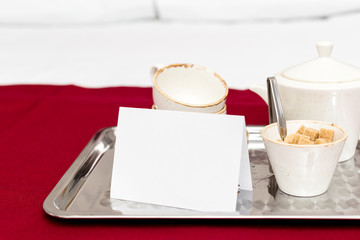 Two white mugs on a tray white bed, breakfast concept