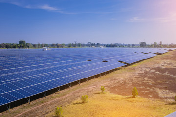 Solar panel stand on the field. Solar power plant farm with sunny sky.