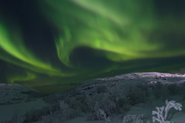 Fototapeta na wymiar Beautiful polar lights ,aurora over hills and tundra in the winter.