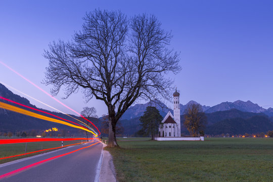 Sunrise on St Coloman Church surrounded by woods. .Schwangau, Fussen, Bavaria, Southwest Bavaria, Germany, Europe.