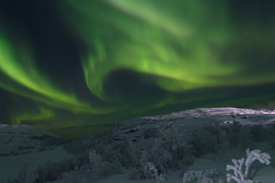 Beautiful polar lights ,aurora over hills and tundra in the winter.