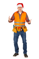 Full length portrait of a male builder in a santa hat  over white wall background. repair, construction, building, people and maintenance concept.