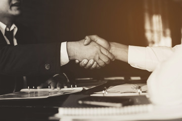 business partners handshaking after business success negotiation at meeting room