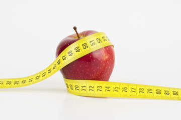 Red apple with measuring tape