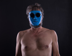 naked man in blue mask