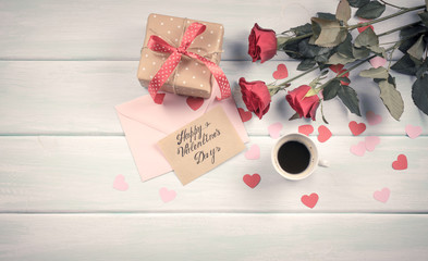 Valentine day. Top view of roses, hearts, gifts, coffee and envelope