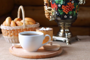 Russian tea from a samovar and pastries in a basket.