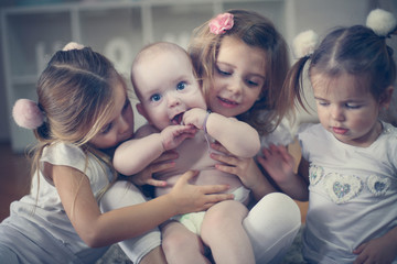 Adorable brothers and sisters poses to camera. Baby boy.