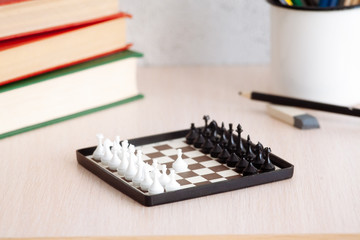 The student's desk, with chess books and pencils.