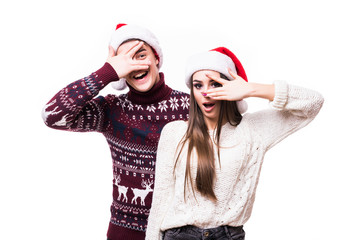 Christmas concept - Happy young couple in sweatesr celebrating christmas with playing and dancing on white background