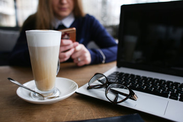 latte on desk with laptop in cafe business