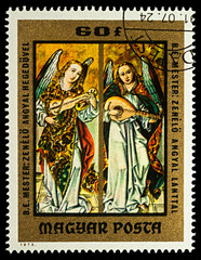 Angels playing violin and lute on postage stamp