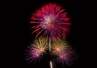 Colourful Fireworks at night over dark sky to celebrate New Year eve and special occasion on holidays