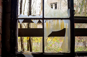 Fototapeta na wymiar A broken window on a lost place factory