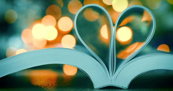 Book page decorate to the heart shape with celebration bokeh light for love and romance of valentines day concept , 4K Dci resolution
