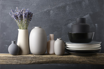 Neutral colored crockery on wooden shelf