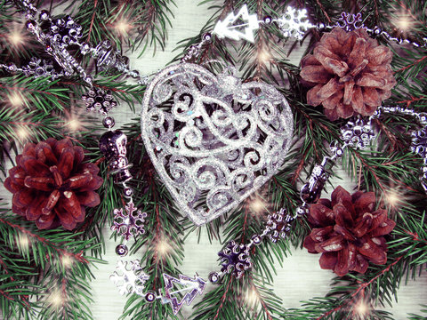 christmas heart decoration on fir branches background