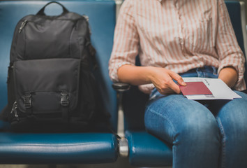 Woman with luggage awaiting her landing at the airport.