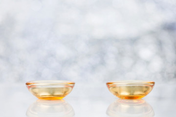 Candles In Glass Cup And Decoration On Blurred Background With Bokeh