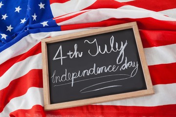 Fototapeta na wymiar American flag and slate with text 4th july independence day